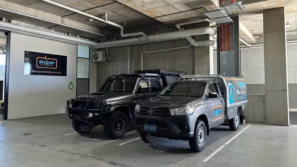 Plumbing service vehicles in a covered parking area